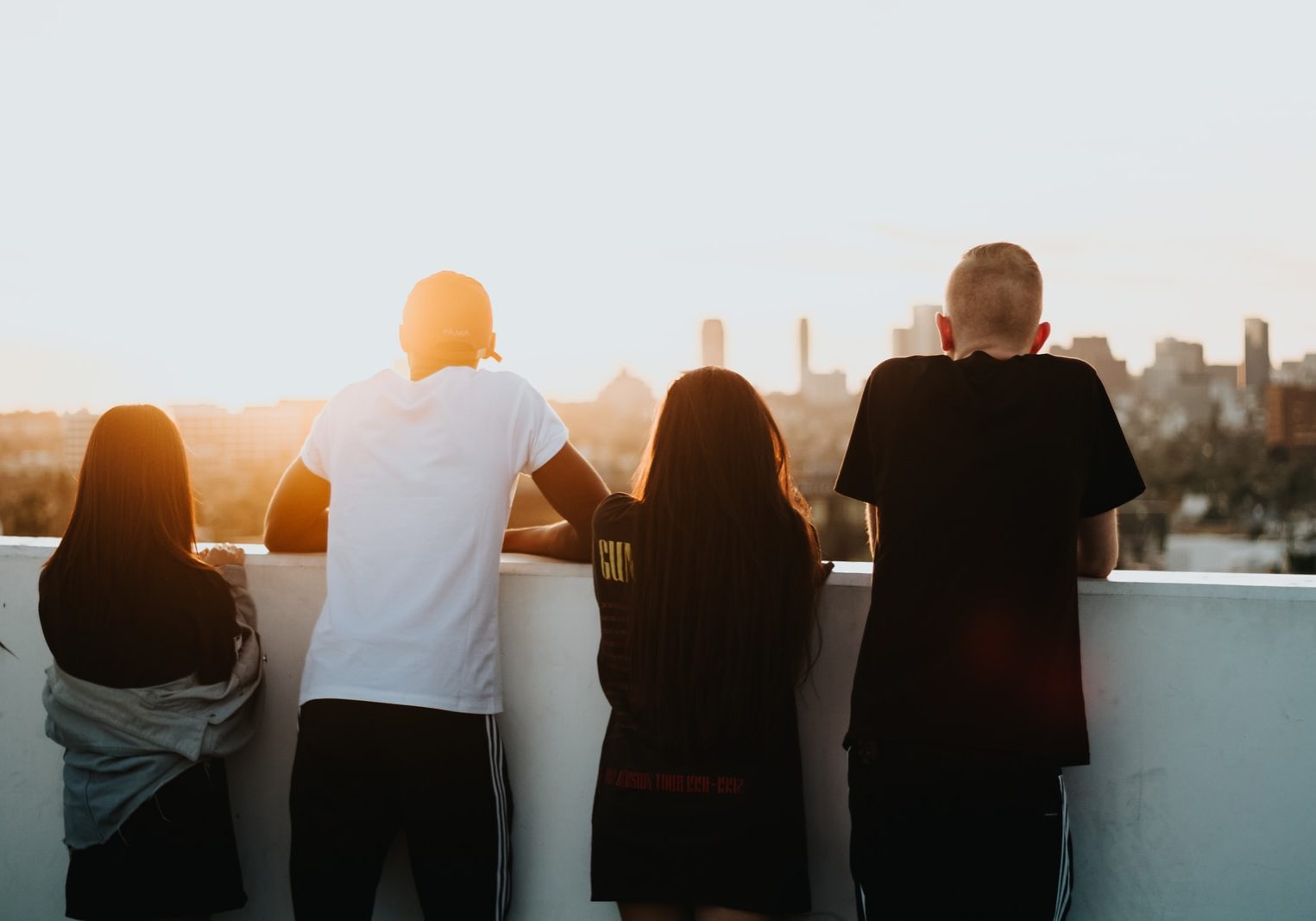 four person looking at the city